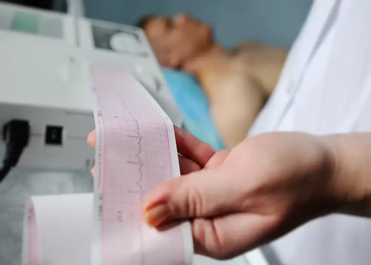 Healthcare professional reading EKG information on patient