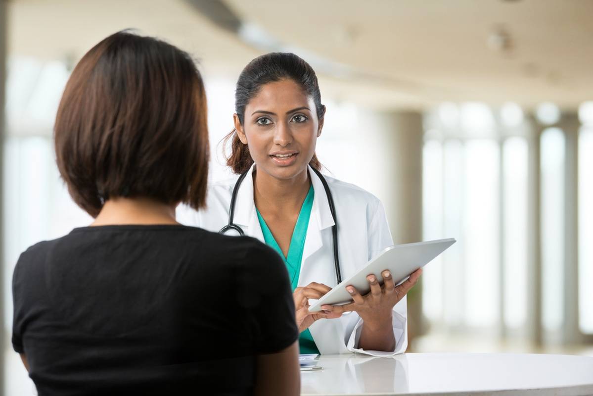 Doctor speaking with patient in large open room