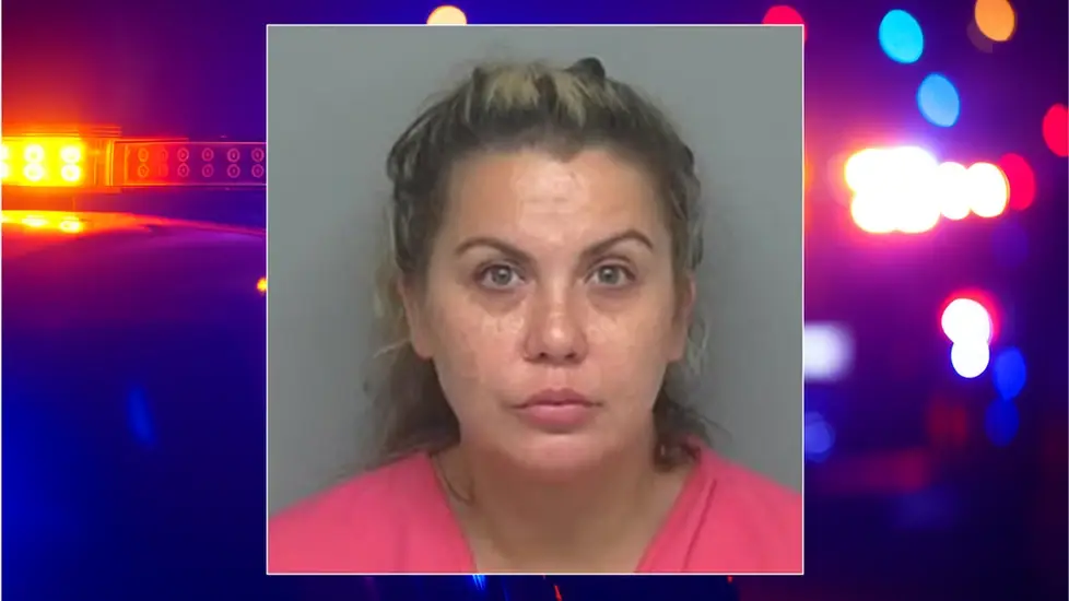 Mugshot of Michelle Davis King over a blurred background of flashing police lights. She is charged in Texas with operating an unlicensed medical spa and performing illegal cosmetic injections.