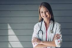 Doctor with rolled up sleeves smiling at the camera