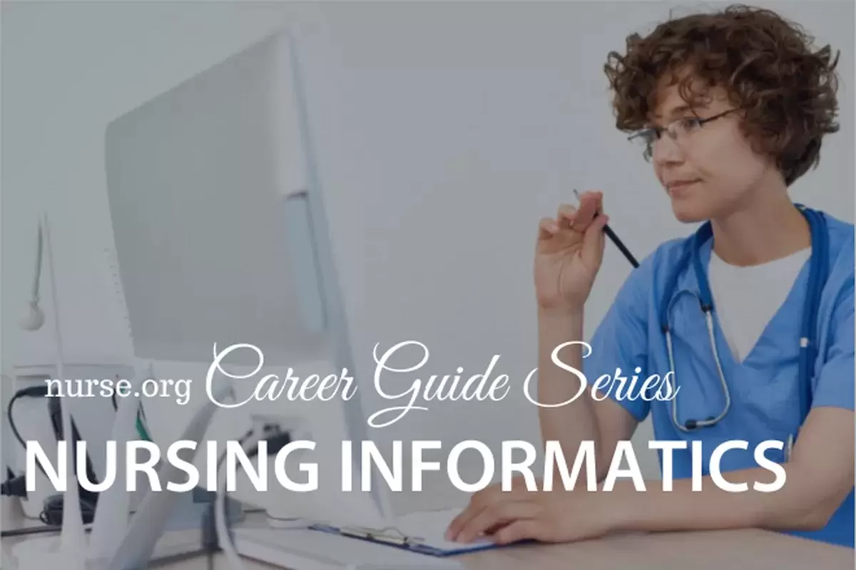 Nurse with glasses working on computer at desk