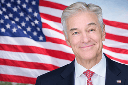 Portrait of Dr. Mehmet Oz with U.S. flag backdrop
