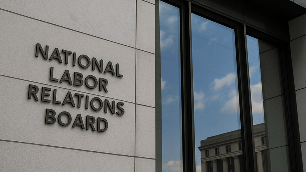 Exterior of the National Labor Relations Board headquarters building, showing the agency’s name mounted on a modern stone facade beside large reflective windows.