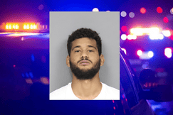 Mugshot of Anthony Garcia with short curly hair, trimmed beard, and neutral facial expression, wearing a white shirt, in front of a plain gray background.