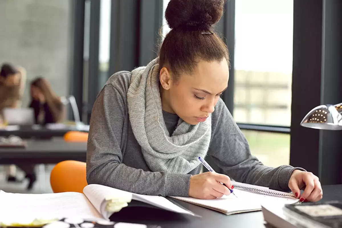 Student in public place studying hard