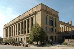 The U.S. District Court for the Southern District of Ohio, a beige stone courthouse with tall columns and a tree near the entrance.